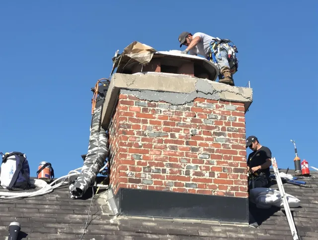 Southbury Chimney Sweep installing a custom chimney crown in Southbury, CT